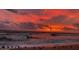 Beach scene with waves crashing on the shore under a vibrant sky at sunset at 68 Hibiscus Dr, Ormond Beach, FL 32176