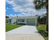 Well-maintained home with a spacious driveway, lush lawn, and inviting front porch at 68 Hibiscus Dr, Ormond Beach, FL 32176