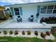 Home exterior featuring a relaxing seating area, colorful flower beds, and meticulous landscaping at 68 Hibiscus Dr, Ormond Beach, FL 32176