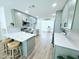 Well-lit kitchen features modern gray cabinetry, stainless steel appliances, and a stylish white countertop island with seating at 68 Hibiscus Dr, Ormond Beach, FL 32176