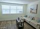 Well-lit living room with a comfortable sofa, beach themed decor, and modern flooring at 68 Hibiscus Dr, Ormond Beach, FL 32176