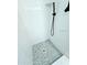 Modern shower with white subway tile and dark fixtures and pebble floor at 68 Hibiscus Dr, Ormond Beach, FL 32176