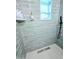 Walk-in shower features sleek gray tile, a black shower head, and a modern drain at 68 Hibiscus Dr, Ormond Beach, FL 32176
