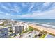 Aerial view showcasing the oceanfront condo and the beautiful beach at 1239 Ocean Shore Blvd # 11D, Ormond Beach, FL 32176