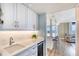 Stylish bar area featuring modern sink and cabinets open to the spacious living area at 1239 Ocean Shore Blvd # 11D, Ormond Beach, FL 32176