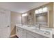 Bright bathroom featuring dual sinks, modern fixtures, and decorative nautical themed decor at 1239 Ocean Shore Blvd # 11D, Ormond Beach, FL 32176