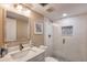 Bright bathroom featuring a glass shower with decorative tile, vanity with marble countertops and neutral wall colors at 1239 Ocean Shore Blvd # 11D, Ormond Beach, FL 32176