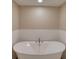Bright bathroom featuring a large soaking tub and decorative tile at 1239 Ocean Shore Blvd # 11D, Ormond Beach, FL 32176