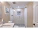 Bright bathroom featuring a glass shower with decorative tile, neutral wall colors, and modern finishes at 1239 Ocean Shore Blvd # 11D, Ormond Beach, FL 32176