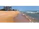 Scenic view of the sandy beach and gentle waves, ideal for relaxation and beachside activities at 1239 Ocean Shore Blvd # 11D, Ormond Beach, FL 32176