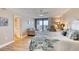 Bright bedroom featuring a balcony, light-colored wood floors, and a comfortable seating area at 1239 Ocean Shore Blvd # 11D, Ormond Beach, FL 32176