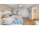 Spacious bedroom featuring a cozy seating area, wood floors, and access to an ensuite bathroom at 1239 Ocean Shore Blvd # 11D, Ormond Beach, FL 32176