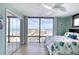 Bright bedroom featuring large windows with ocean views and a closet with mirrored doors at 1239 Ocean Shore Blvd # 11D, Ormond Beach, FL 32176