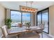 Dining area with modern light fixture offering scenic views from large windows at 1239 Ocean Shore Blvd # 11D, Ormond Beach, FL 32176