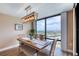 Dining area with rustic light fixture providing city views from the adjacent large windows at 1239 Ocean Shore Blvd # 11D, Ormond Beach, FL 32176