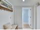 Inviting hallway with a decorative bench, coat hooks, and doorway leading to the interior of the home at 1239 Ocean Shore Blvd # 11D, Ormond Beach, FL 32176