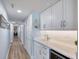 Inviting hallway with light blue walls and a bar area leading to various rooms at 1239 Ocean Shore Blvd # 11D, Ormond Beach, FL 32176