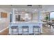 Well-equipped kitchen with white cabinetry, a marble countertop island, and seating for casual dining at 1239 Ocean Shore Blvd # 11D, Ormond Beach, FL 32176