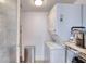 Laundry room with washer, dryer, shelving, and stainless steel trash can at 1239 Ocean Shore Blvd # 11D, Ormond Beach, FL 32176