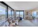 Bright living room features floor-to-ceiling windows, ocean views, and a comfortable seating area with luxury vinyl plank flooring at 1239 Ocean Shore Blvd # 11D, Ormond Beach, FL 32176