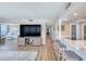 Open-concept living room features ocean view, large TV, and bar seating with luxury vinyl plank flooring at 1239 Ocean Shore Blvd # 11D, Ormond Beach, FL 32176