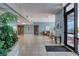 Spacious building lobby with tile flooring, lush plant life, and ample seating areas at 1239 Ocean Shore Blvd # 11D, Ormond Beach, FL 32176