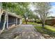 Backyard view with a patio and grass, surrounded by mature trees and a wooden fence at 1317 Northside Dr, Ormond Beach, FL 32174