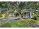 The backyard features a nice patio, mature trees, a grassy area, and a fence at 1317 Northside Dr, Ormond Beach, FL 32174