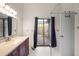 Bathroom featuring a wood vanity cabinet with drawers, countertop, sink, and chrome faucet with access to backyard at 1317 Northside Dr, Ormond Beach, FL 32174