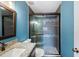 Stylish bathroom with a glass shower, granite sink, and blue walls at 1317 Northside Dr, Ormond Beach, FL 32174