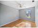 This bedroom has light blue walls, a wood floor and a ceiling fan at 1317 Northside Dr, Ormond Beach, FL 32174