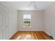 Cozy bedroom with hardwood floors, natural light, and closet at 1317 Northside Dr, Ormond Beach, FL 32174
