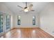 Bedroom showcasing hardwood floors, neutral walls, two windows, and access to an outdoor patio at 1317 Northside Dr, Ormond Beach, FL 32174