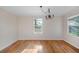 Empty bedroom with hardwood floors, neutral walls, and a chandelier at 1317 Northside Dr, Ormond Beach, FL 32174