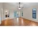 Bright bedroom with hardwood floors, ceiling fan, and access to a bathroom at 1317 Northside Dr, Ormond Beach, FL 32174