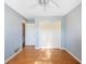 Comfortable bedroom with hardwood floors, light blue walls, and a double door closet with hardware at 1317 Northside Dr, Ormond Beach, FL 32174
