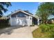 Attractive house with a two-car garage, gray siding, and manicured landscaping at 1317 Northside Dr, Ormond Beach, FL 32174