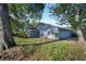 Exterior view of the home showing the siding, landscaping, and large trees at 1317 Northside Dr, Ormond Beach, FL 32174