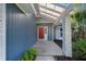 View of the front entrance featuring red door, textured column, and clerestory at 1317 Northside Dr, Ormond Beach, FL 32174