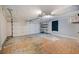 The garage features a garage door, overhead lighting and storage shelves at 1317 Northside Dr, Ormond Beach, FL 32174