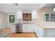 Modern kitchen featuring white cabinets, stainless steel appliances, and granite countertops at 1317 Northside Dr, Ormond Beach, FL 32174