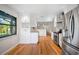 Bright kitchen featuring stainless steel appliances, granite countertops, and white cabinets with hardwood flooring at 1317 Northside Dr, Ormond Beach, FL 32174