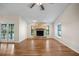 Open-concept living room with hardwood floors, stone fireplace, and lots of natural light at 1317 Northside Dr, Ormond Beach, FL 32174