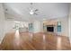 Spacious living room with hardwood floors and a stone fireplace as the focal point at 1317 Northside Dr, Ormond Beach, FL 32174