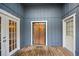 View of a covered patio with a wood floor and access to the backyard at 1317 Northside Dr, Ormond Beach, FL 32174