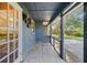 View of a covered patio with tile flooring and a decorative metal wall hanging at 1317 Northside Dr, Ormond Beach, FL 32174