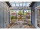 View of a covered patio with wood flooring and a view of the fenced backyard at 1317 Northside Dr, Ormond Beach, FL 32174