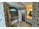 Bathroom with floral wallpaper, a corner shower, a soaking tub, and white cabinets at 16 Hunt Master Ct, Ormond Beach, FL 32174