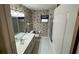 This bathroom has a vanity, toilet, floral wallpaper, shower and window at 16 Hunt Master Ct, Ormond Beach, FL 32174