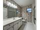 This traditional bathroom features a large mirror, decorative wallpaper, shower, and tiled floors at 16 Hunt Master Ct, Ormond Beach, FL 32174